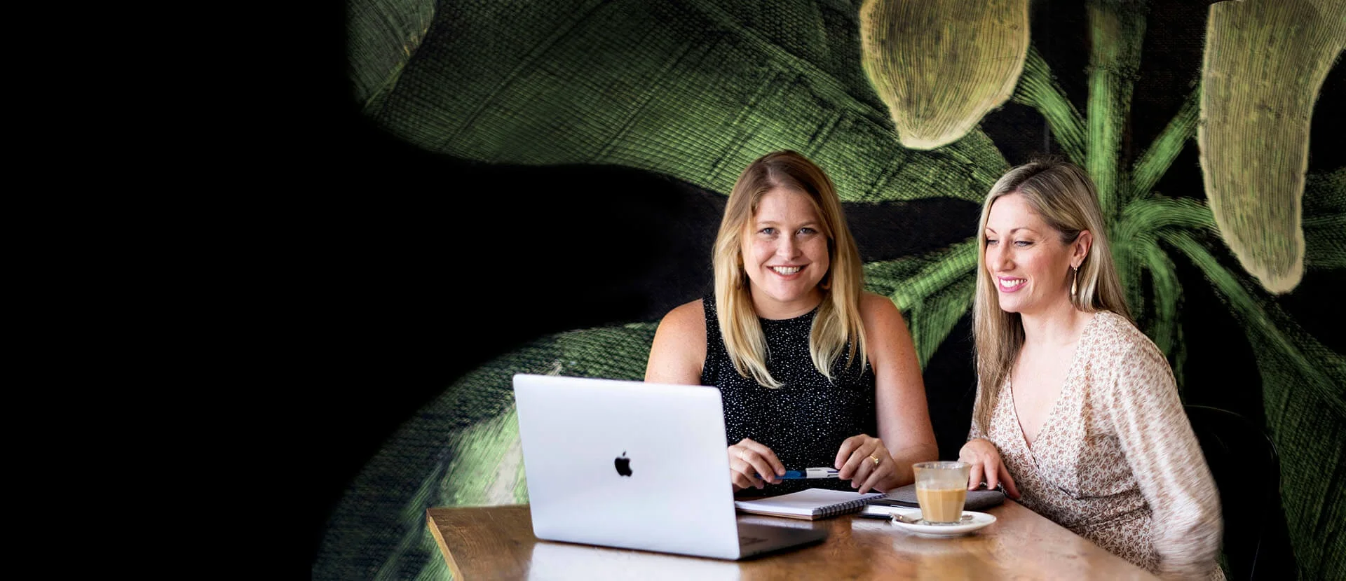 The Mino Design and Digital team working together at a Brisbane cafe